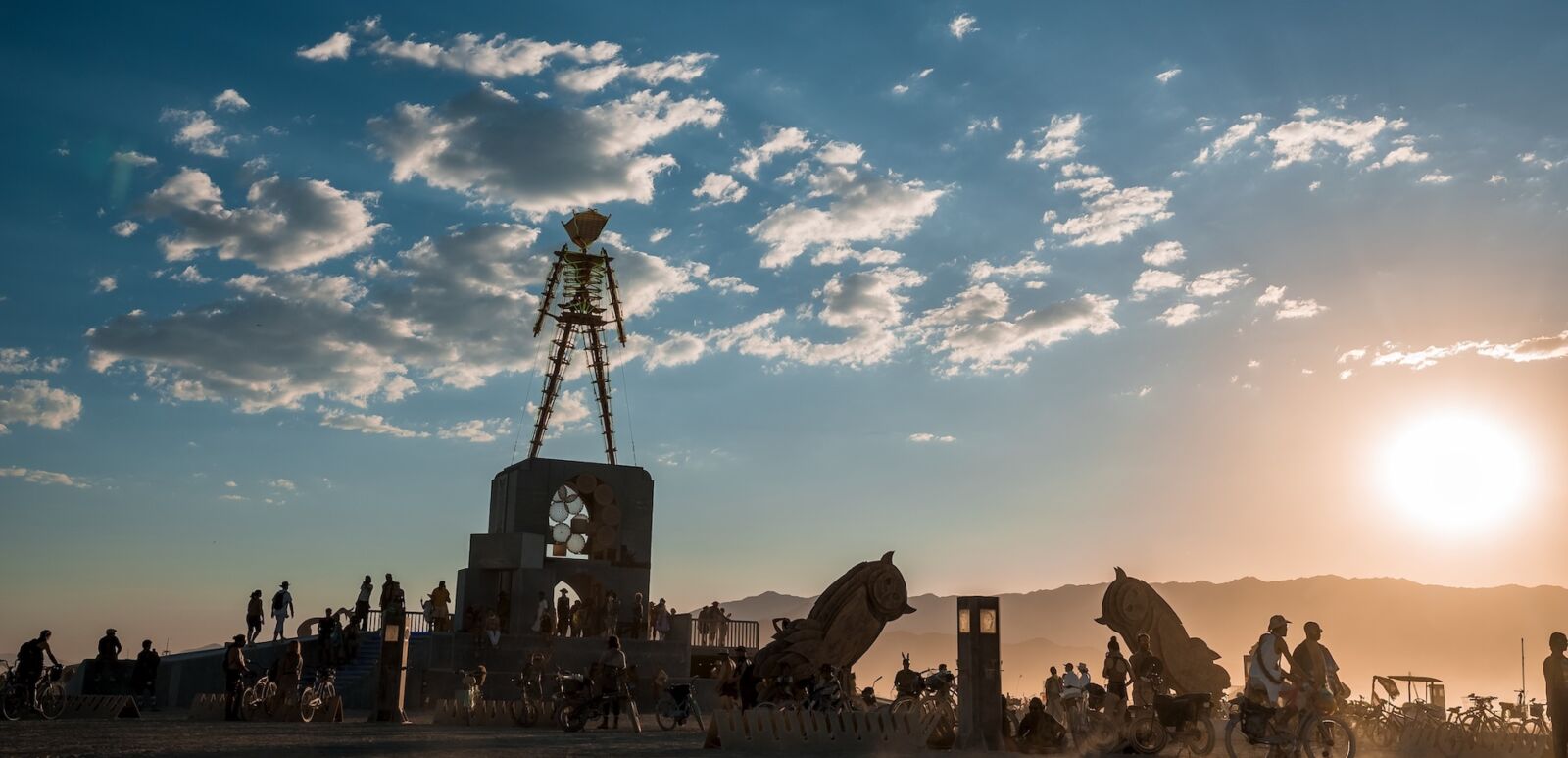 Nevada, United States. September 10, 2022. Beautiful desert with art objects at sunrise. Beautiful nature festival with people riding bicycles. Burning Man festival.