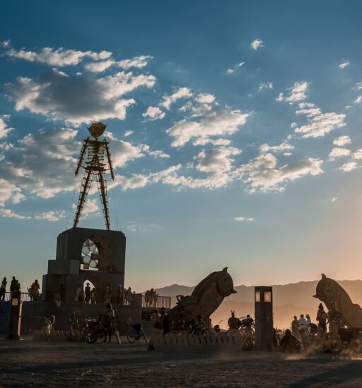 Nevada, United States. September 10, 2022. Beautiful desert with art objects at sunrise. Beautiful nature festival with people riding bicycles. Burning Man festival.