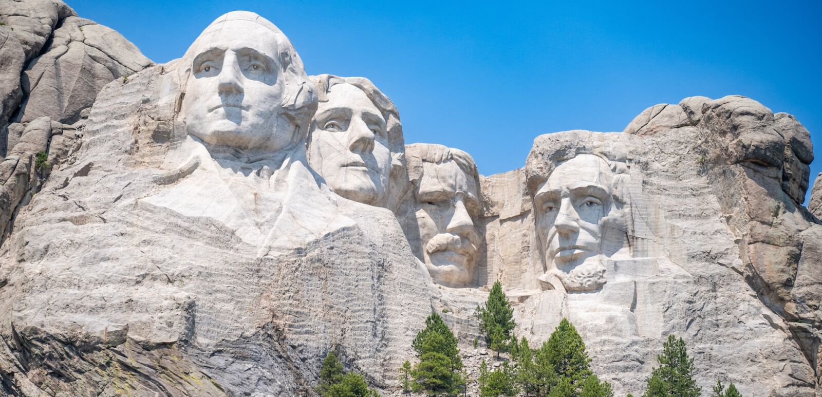 Mount Rushmore in the Black Hills of South Dakota against a clear sky.