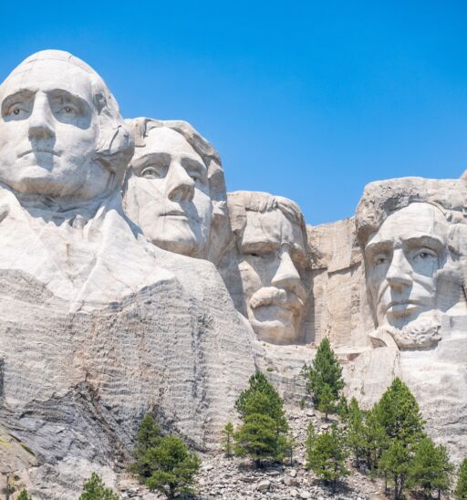 Mount Rushmore in the Black Hills of South Dakota against a clear sky.