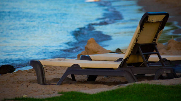 A lawn chair set on the beach at Clinch Park of West Traverse City Bay Area, Michigan. The popular beach park features over 1500 feet of sand along lake Michigan and has many outdoor activities.