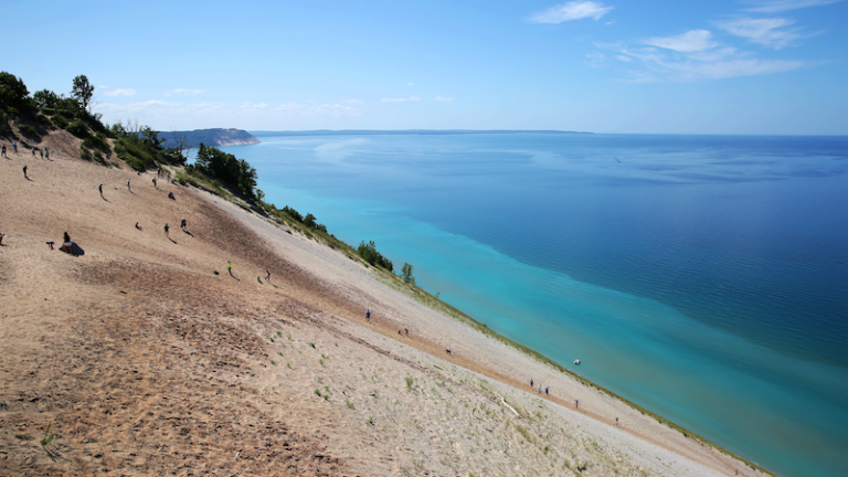 Tourists climbing steep sand dunes at Sleeping Bear Dunes National Lakeshore, Michigan