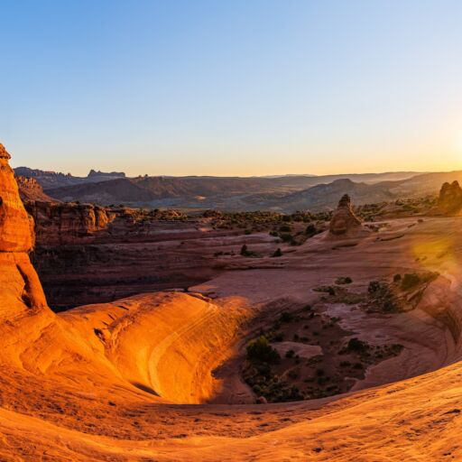 Delicate Arch - The most famous landmark of the Arches National Park in Utah in strong sunlight during sunset.