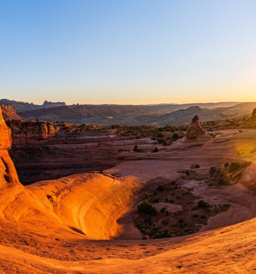 Delicate Arch - The most famous landmark of the Arches National Park in Utah in strong sunlight during sunset.