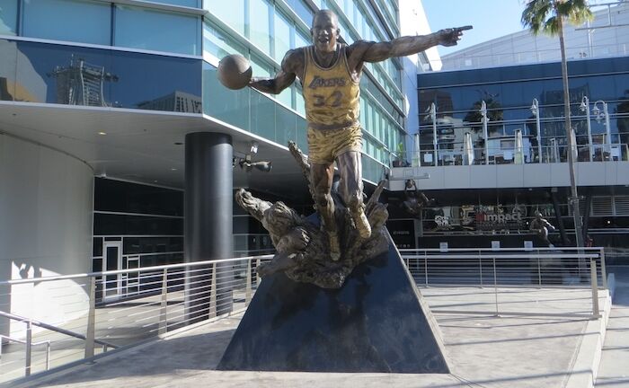 Los Angeles, California, USA, June 20, 2022: Crypto.com Arena Star Plaza. Magic Johnson Bronze Statue. Photo via Shutterstock.